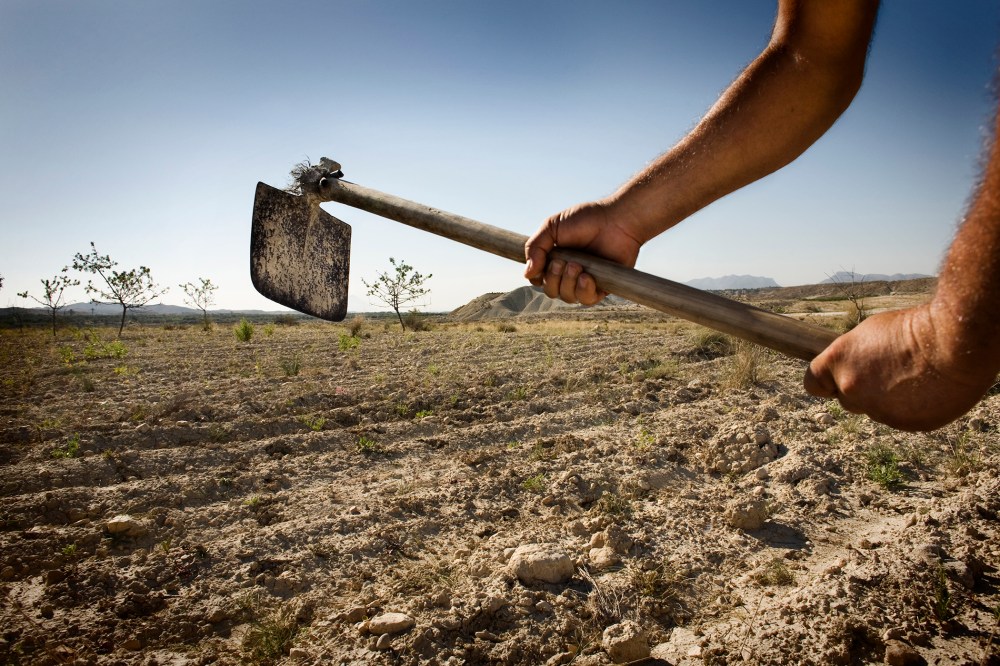 A farmer works his field in Albanilla, Spain.