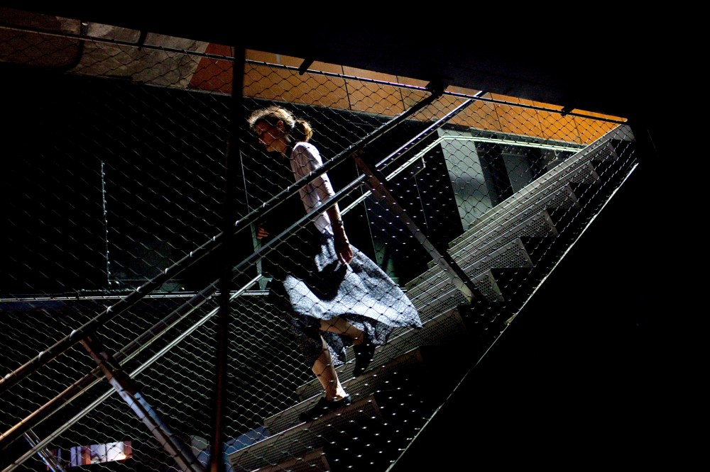 A walks on a stairway at the High Line Park in New York City.