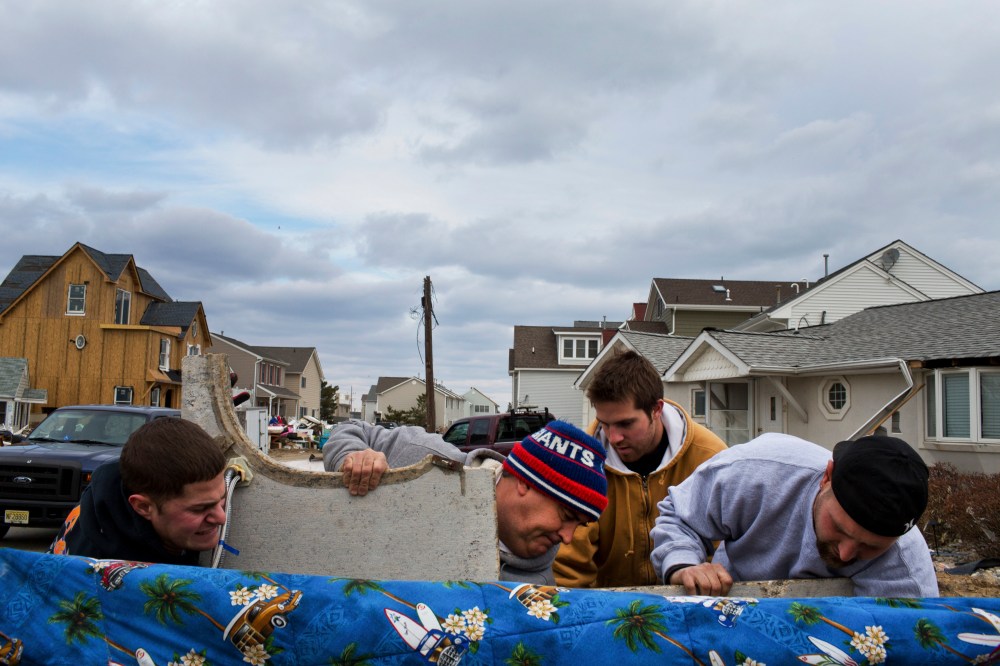 Residents of Ortley Beach, N.J. remove debris after returning for the first time since Hurricane Sandy pulverized the area, Nov. 25, 2012.