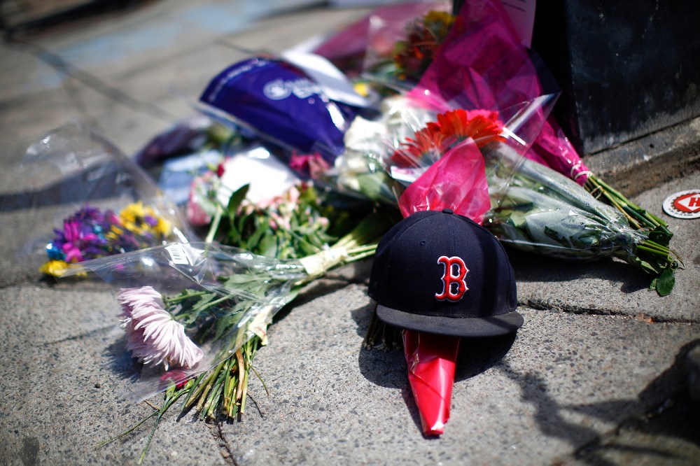 A makeshift memorial on the sidewalk on Newbury Street near the site of two bomb explosions that occurred during the Boston Marathon, April 18, 2013.