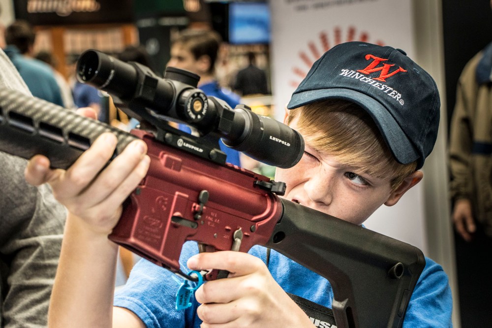 A twelve year old boy visits the Bushmaster booth during Family Day at the NRA convention at Lucas Oil Stadium in Indianapolis, April, 2014.