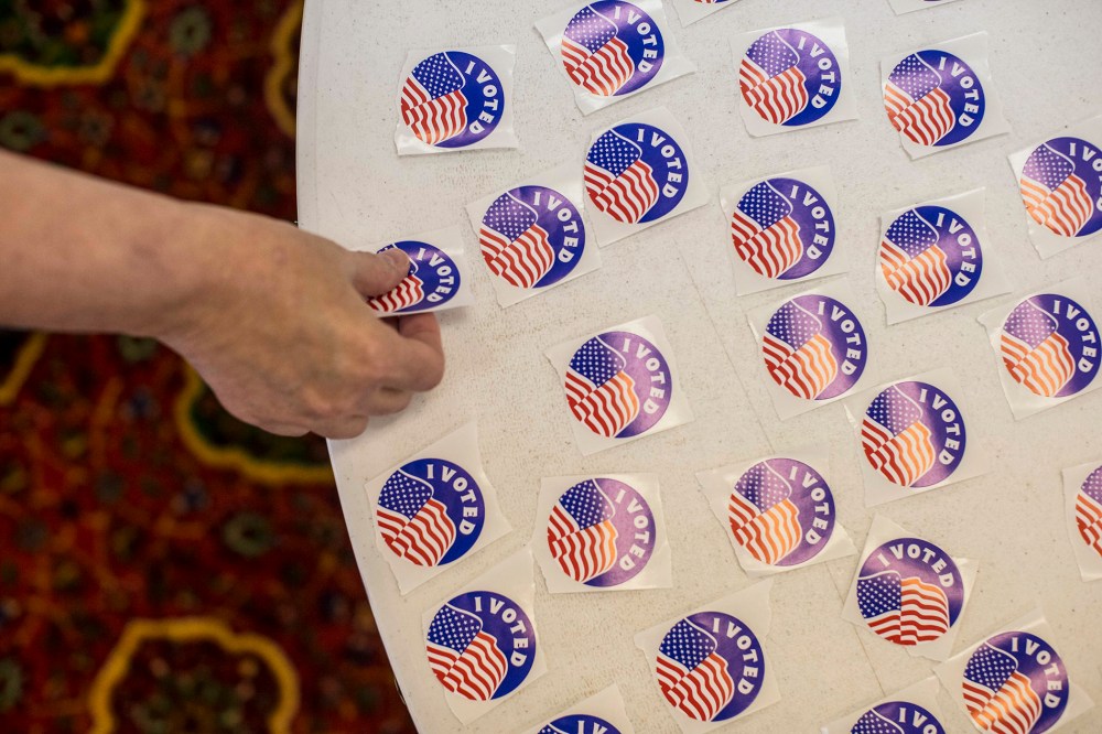 A voter picks up a sticker after casting their ballot in a polling station at the Mahatma Ghandi Center in Ballwin, Mo. (Photo by Whitney Curtis/The New York Times/Redux)