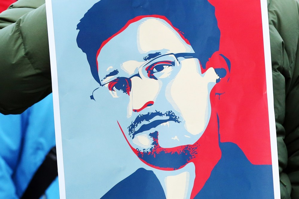 A demonstrator holds a poster of Edward Snowden in Hamburg, Germany, Dec. 28, 2013.