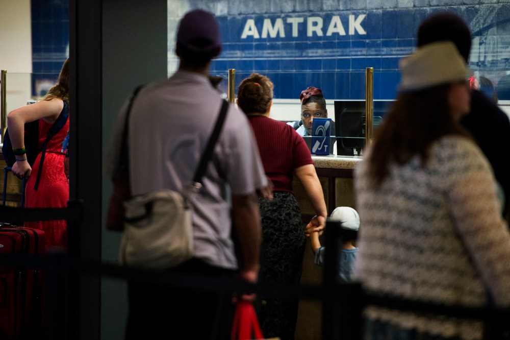 Travelers stand in line for tickets and information at the Amtrak desk at Union Station in Washington, DC on May 13, 2015. (Photo by Shawn Thew/EPA)