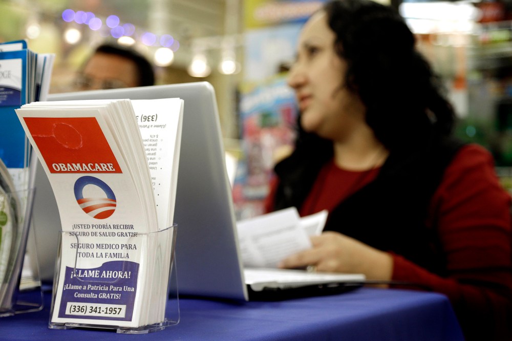 Blue Bridge Benefits LLC agent Patricia Sarabia helps customers interested in Obama Care at a kiosk at Compare Foods in Winston-Salem, N.C. on Nov. 22, 2014.
