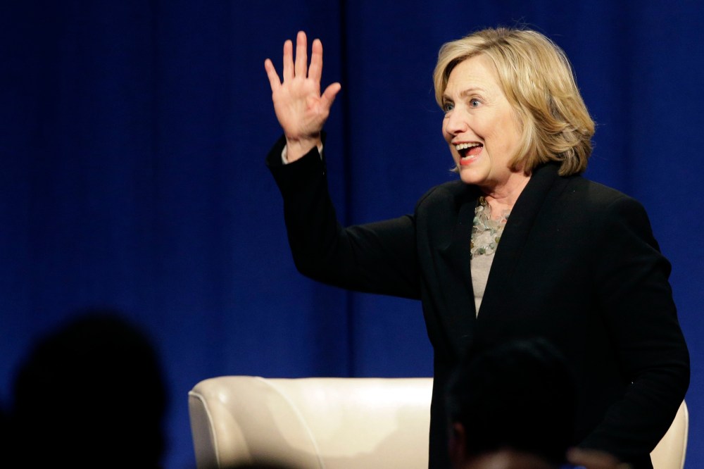 Former U.S. Secretary of State Hillary Rodham Clinton waves as she leaves the Economic Club of Chicago in Chicago on Oct. 8, 2014. (Nam Y. Huh/AP)