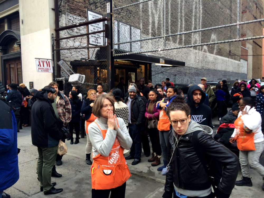 Home Depot employees and customers stand outside a store after shots were fired in a Chelsea, New York City location on Jan. 25, 2015. (Photo by David Hashim/MSNBC)