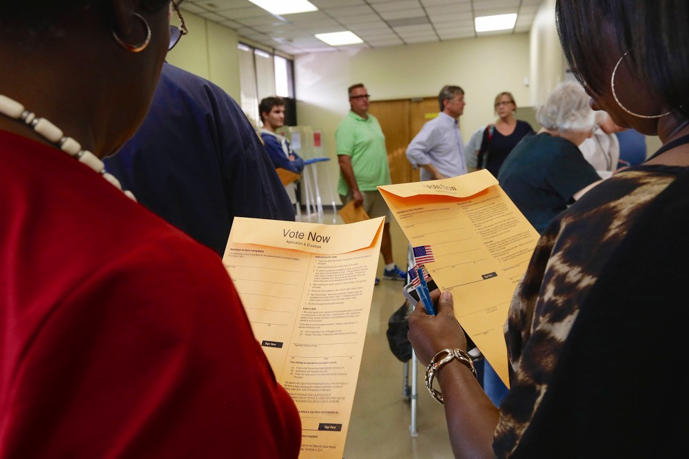 Early voters wait in line to get their ballots at the Douglas County Election Commission offices in Omaha, Neb., on Oct. 24, 2014.