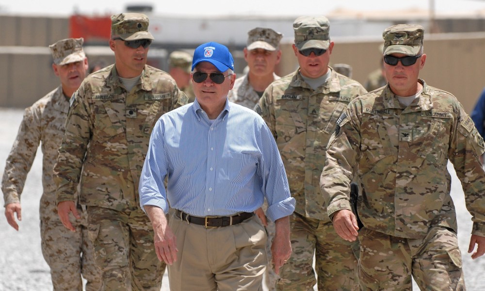 In this photo provided by ISAF Regional Command (South), U.S. Secretary of Defense Robert M. Gates walks with a group of service members at Forward Operating Base Walton, Sunday, June 5, 2011, in Kandahar, Afghanistan.