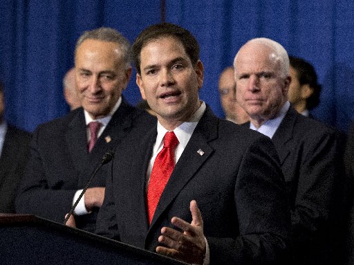 Sen. Marco Rubio, R-Fla., flanked by Sen. Charles Schumer, D-N.Y., left, and Sen. John McCain, R-Ariz., right, speaks about immigration reform legislation as outlined by the Senate's bipartisan "Gang of Eight" April 18, 2013, on Capitol Hill in...