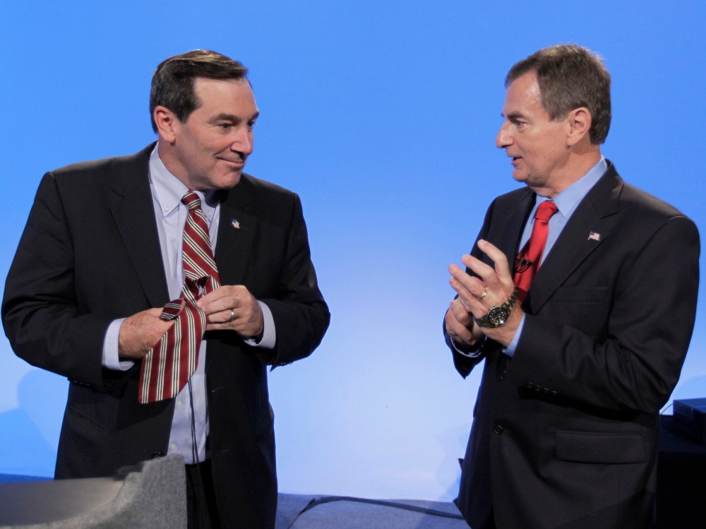Democrat Joe Donnelly, left, and Republican Richard Mourdock talk after participating in a debate in Indianapolis, Monday, Oct. 15, 2012. (Photo by AP Photo/Michael Conroy)