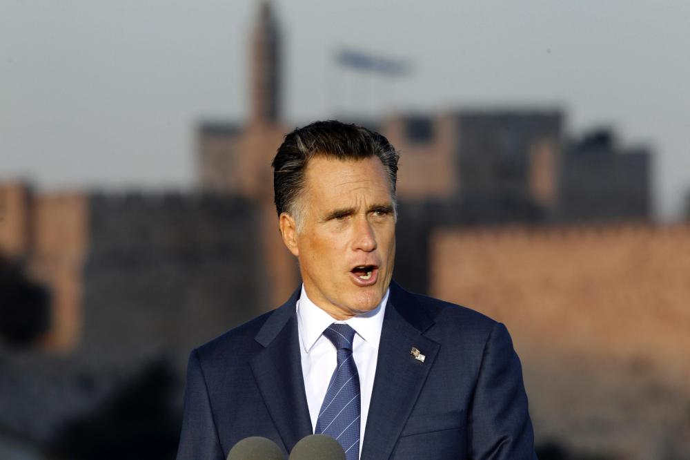 Mitt Romney, sporting a double USA-Israel flag pin, delivers a speech yesterday in Jerusalem.