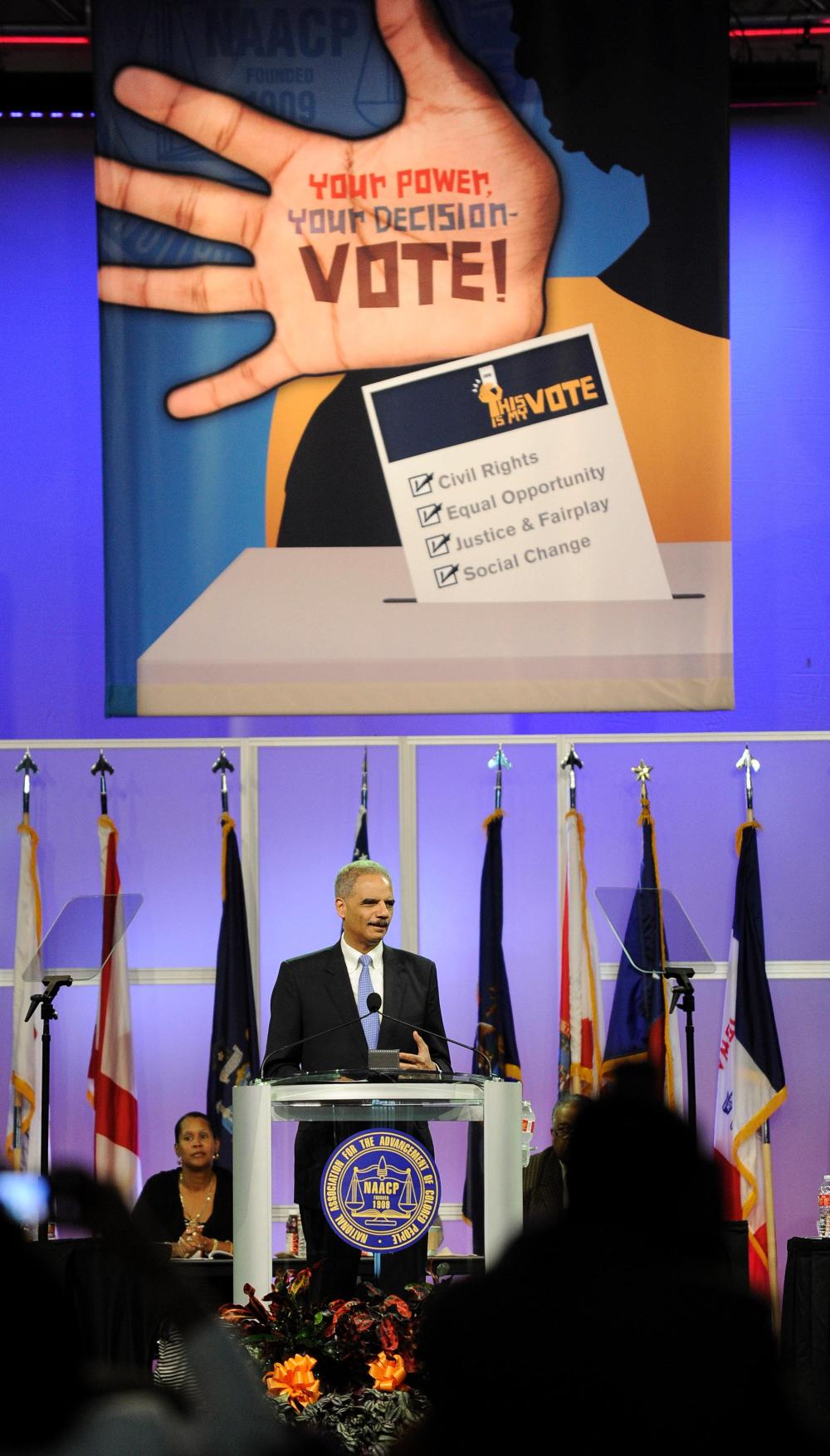 Attorney General Eric Holder addresses the NAACP on Tuesday.