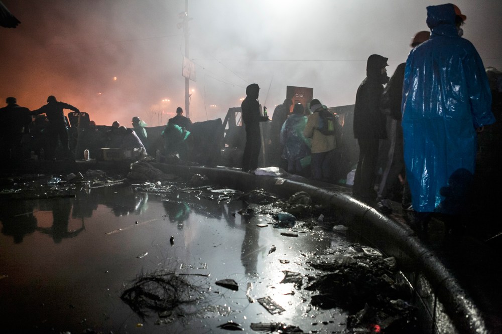Anti-government demonstrators stand behind a barricade near Kiev's Independence Square on Feb. 19, 2014.