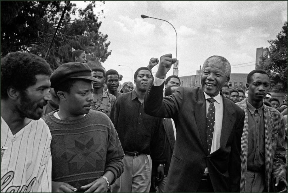 Nelson Mandela surprises locals on an impromptu walkabout in South Africa, 1994.