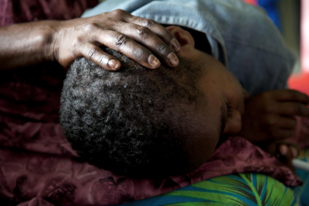 Selina Clement holds her 7-year-old son Emanuel at an HIV drop in center in Port Moresby, Papua New Guinea. Both are HIV positive.