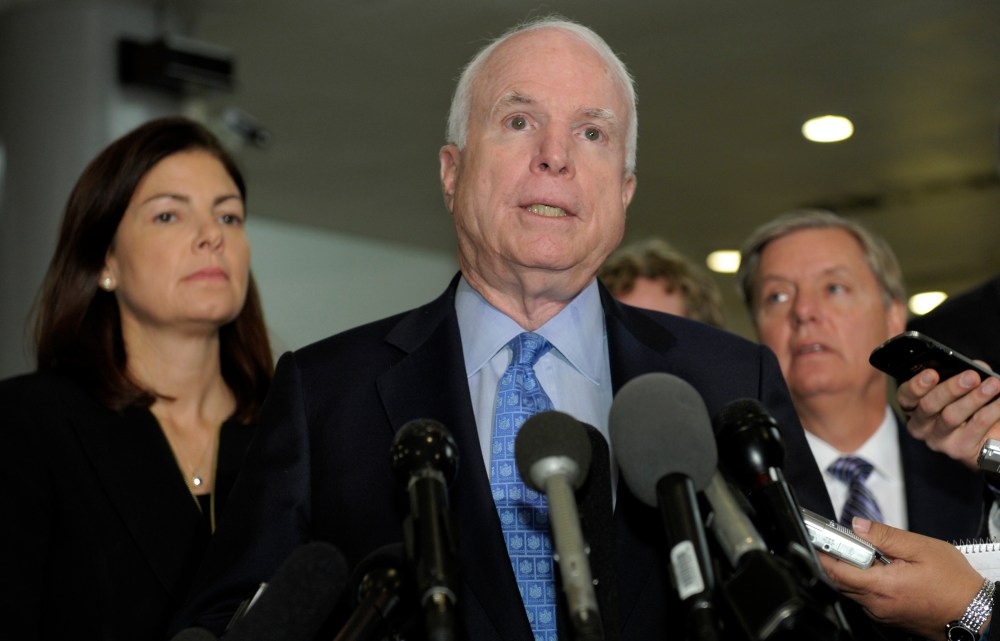 Sen. John McCain, R-Ariz., ranking Republican on the Senate Armed Services Committee, center, flanked by fellow committee members, Sen. Kelly Ayotte, R-N.H., left, and Sen. Lindsey Graham, R-S.C., right, speaks  on Capitol Hill in Washington, Tuesday,...