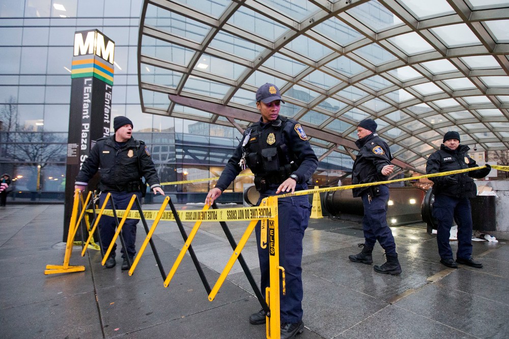 Metro Transit Police officers, secure the entrance to L'­Enfant Plaza Station in Washington, D.C., Jan. 12, 2015. (Photo by Manuel Balce Ceneta/AP)
