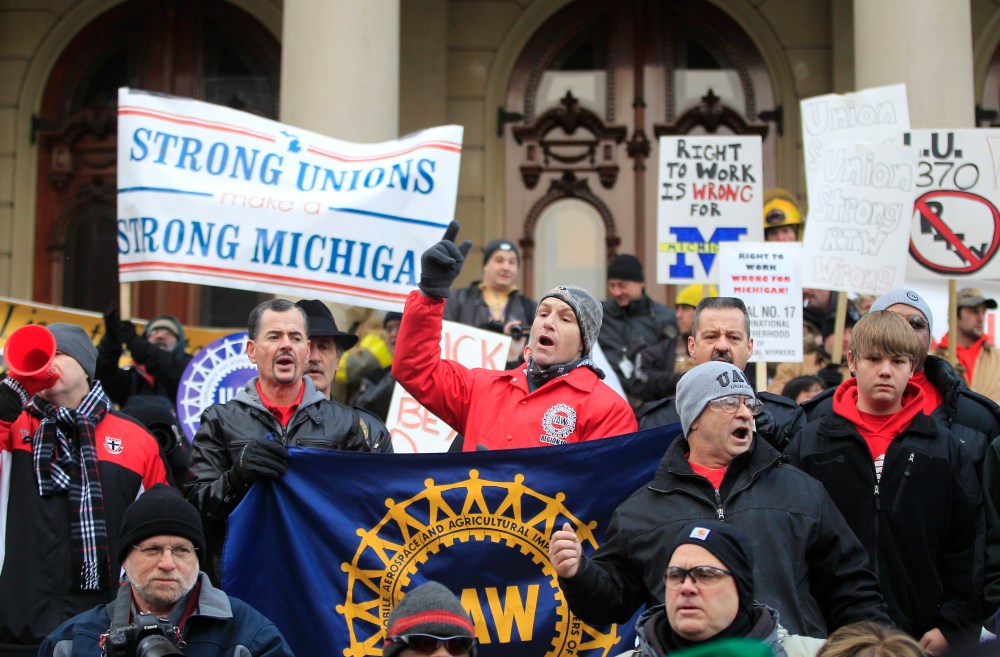 Large right-to-work protests, like the one here in Lansing, MI, are expected throughout the state today.(AP Photo/Carlos Osorio)