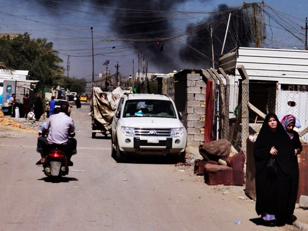 Smoke rises after a car bomb attack in Sadr City, Baghdad, Iraq, Tuesday, March 19, 2013. A wave of apparently coordinated bombings rumbled across the Iraqi capital Tuesday morning, killing and wounding scores of people, police said. (Photo by Karim...