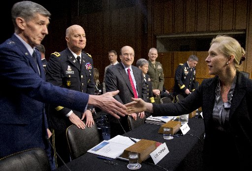 Senate subcommittee on Personnel Chair Sen. Kirsten Gillibrand, D-N.Y., right, greets members of the third panel, from left, Lt. Gen. Richard Harding, Judge Advocate General of the United States Air Force; Lt. Gen. Dana Chipman, Judge Advocate General...