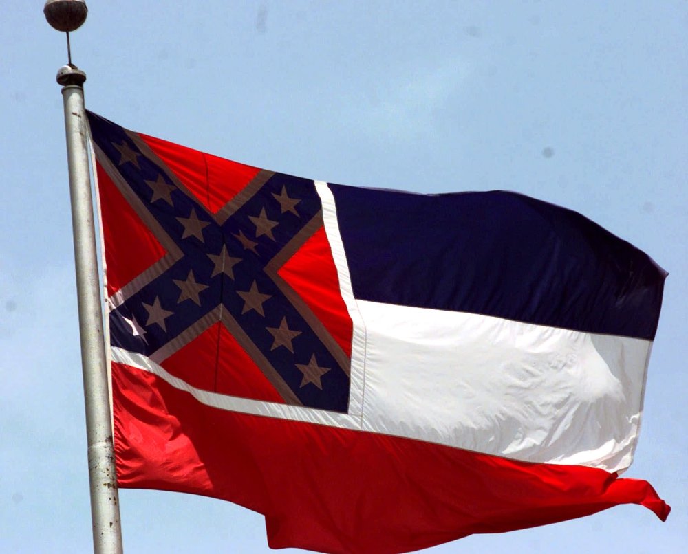 The Mississippi flag, photographed at the Capitol in Jackson, has been compared to a "badge of slavery," by civil rights groups.  (Photo by Rogelio Solis/AP)