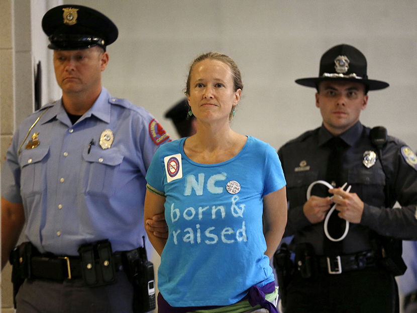 A woman is arrested outside the House and Senate chambers during "Moral Monday" protests at the General Assembly in Raleigh, N.C., Monday, June 24, 2013. (Photo by Gerry Broome/AP)