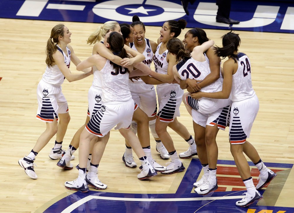 Members of Connecticut celebrate after defeating Syracuse in the championship game at the women's Final Four in the NCAA college basketball tournament, April 5, 2016, in Indianapolis. (Photo by Darron Cummings/AP)