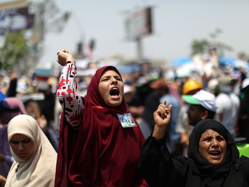 Supporters of deposed Egyptian president Mohamed Morsi shout slogans during a rally in support of the former Islamist leader outside Cairo's Rabaa al-Adawiya mosque on July 9, 2013.  (Photo by Mahmud Hamsmahmud Hams/AFP/Getty Images)