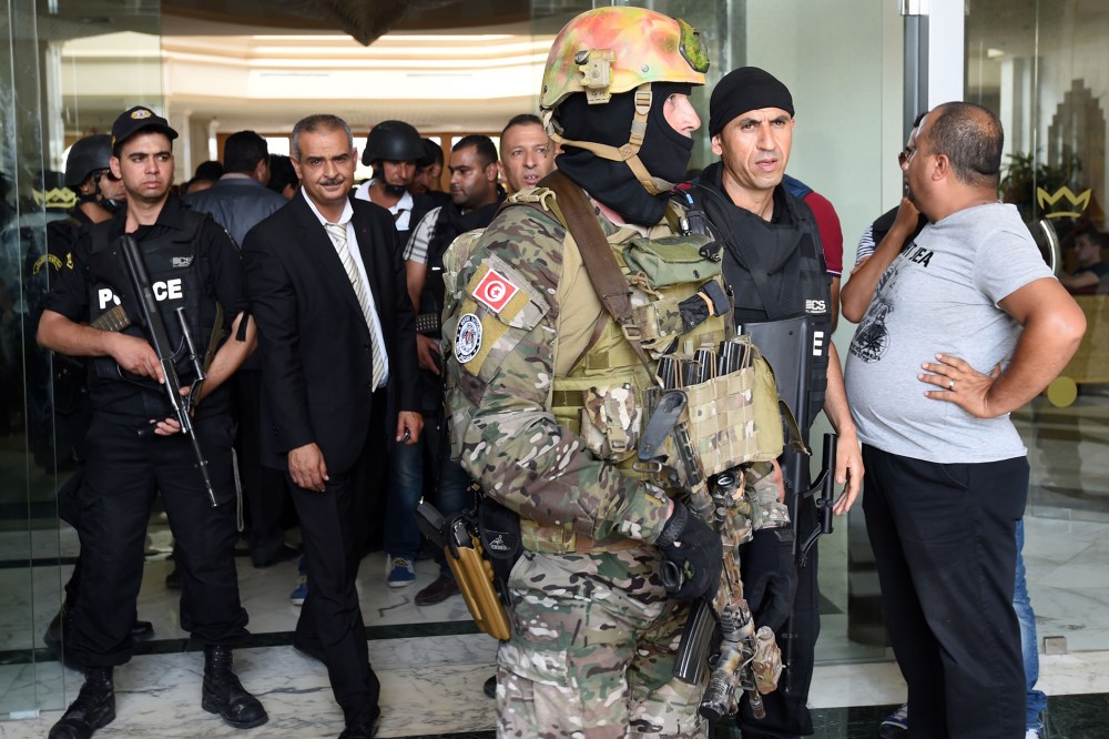 Tunisian security forces stand in front of the Imperial hotel in the resort town of Sousse, a popular tourist destination 140 kilometres (90 miles) south of the Tunisian capital, on June 26, 2015, following a shooting attack. (Fethi Belaid/AFP/Getty)
