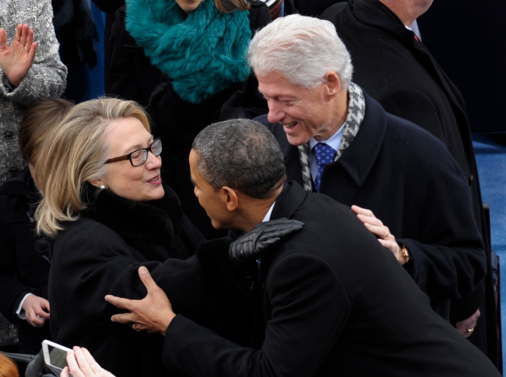 President Barack Obama is greeted by Secretary of State Hillary Clinton and former President Bill Clinton for his ceremonial swearing-in at the U.S. Capitol during the 57th Presidential Inauguration in Washington, Monday, Jan. 21, 2013. (Photo by Susan...