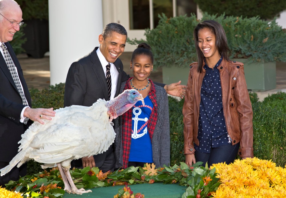 President Barack Obama, with daughters Sasha, center, and Malia, right, carries on the Thanksgiving tradition of saving a turkey from the dinner table with a "presidential pardon," at the White House in Washington, Wednesday, Nov. 21, 2012. After the...