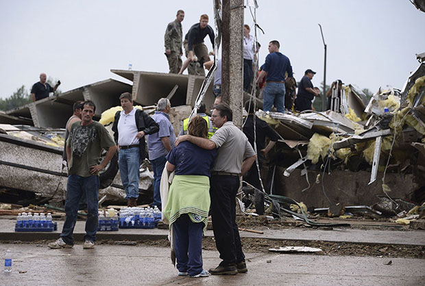 Residents and rescuers look over the damage after a tornado struck Moore, Oklahoma, May 20, 2013. A huge tornado with winds of up to 200 miles per hour (320 kph) devastated the Oklahoma City suburb of Moore on Monday, ripping up at least two elementary...