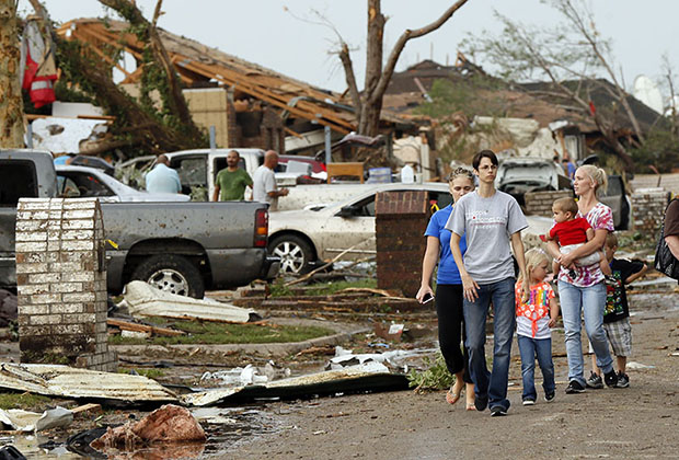 People walk through a neighborhood south of SW 149th between Western and Hudson after a tornado struck south Oklahoma City and Moore, Okla., Monday, May 20, 2013. (AP Photo/ The Oklahoman, Nate Billings)