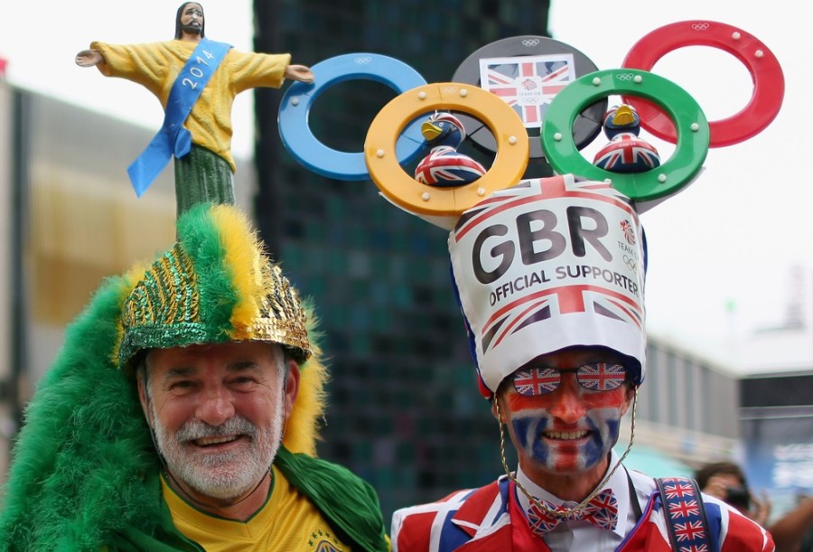 Fans pose at the entrance of Olympic Park before the opening ceremony on July 27.