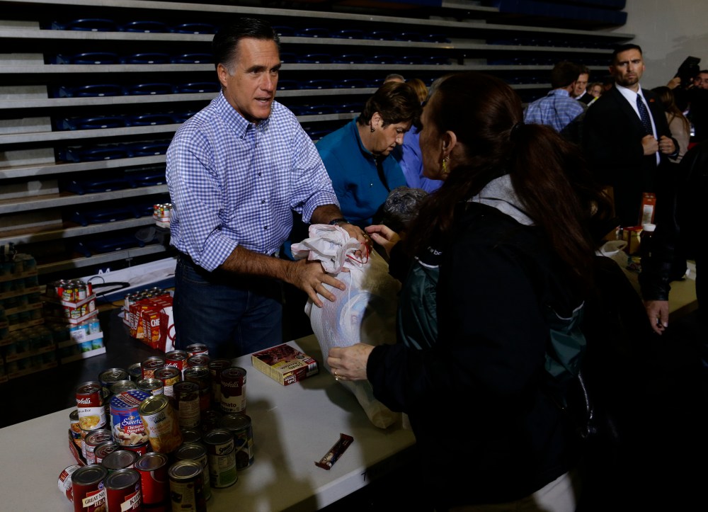 Republican presidential candidate and former Massachusetts Gov. Mitt Romney receives food donations as he participates in a campaign event collecting supplies from residents local relief organizations for victims of superstorm Sandy at the James S....