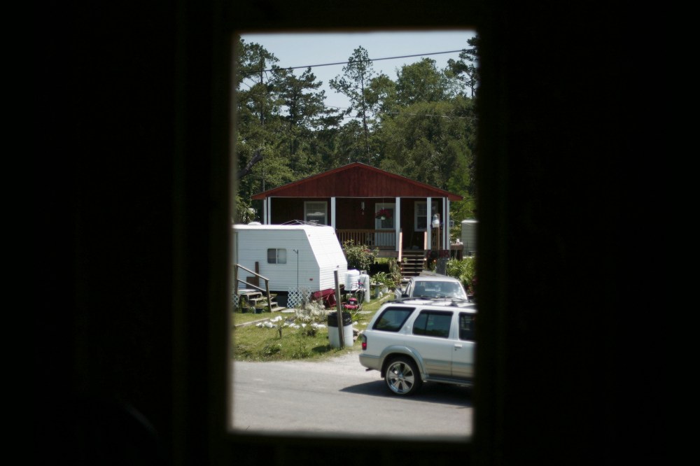 A rebuilt house is seen from an other, both destroyed by hurricane Katrina nearly two years before at Pearlington, Miss., May 10, 2007. (Photo by Carlos Barria/Reuters)