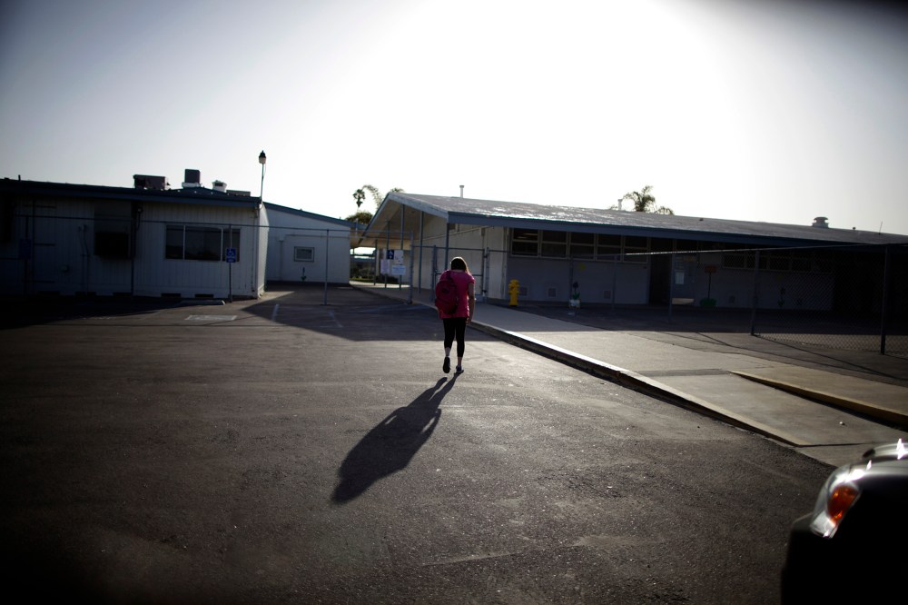 Melinda Guzman, 12, walks into her school in Port Hueneme, some 65 miles northwest of Los Angeles, California on Feb. 28, 2012.