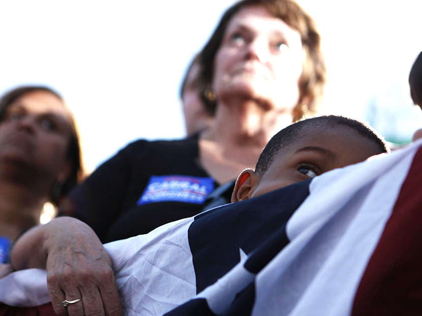 Supporters listen to U.S. President Obama speaking at a campaign event at Loudoun County High School in Leesburg