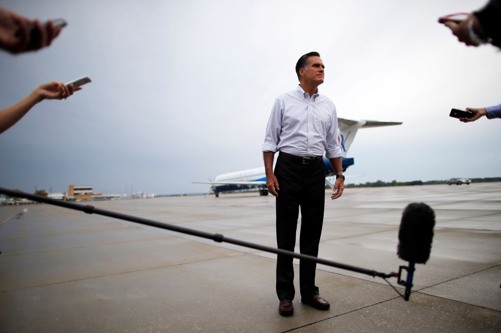 Then, Republican presidential candidate and former Massachusetts Governor Mitt Romney listens to a question from a reporter at the airport in Sergeant Bluff, Iowa on Sept. 7, 2012. (Photo by Brian Snyder/Reuters)
