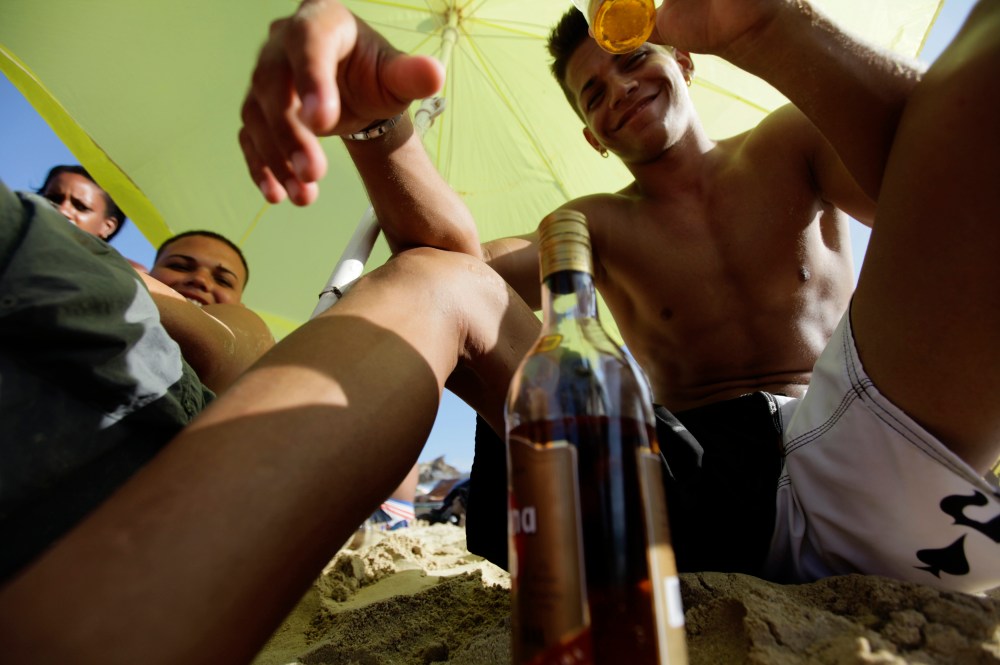 Cubans drink rum at beach on the outskirts of Havana