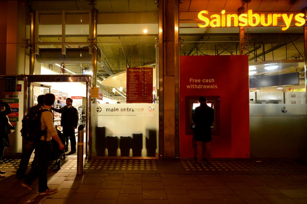 A security guard locks the door to a Sainsbury store in central London on Dec. 23, 2012.