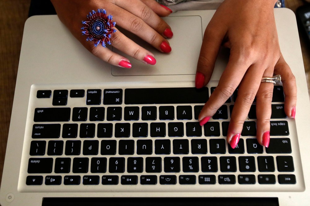 The hands of Malini Agarwal, blogger-in-chief of missmalini.com, are pictured as she blogs from her living room in Mumbai
