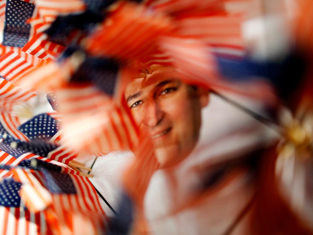 A picture of U.S. Senator Cruz is surrounded by small U.S. flags at a booth at the Conservative Political Action Conference in National Harbor, Maryland