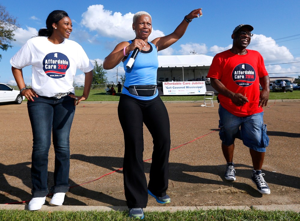 Deborah Jones leads local residents in an exercise at a rally held by supporters of the Affordable Care Act outside the Jackson-Hinds Comprehensive Health Center in Jackson, Mississippi October 4, 2013.