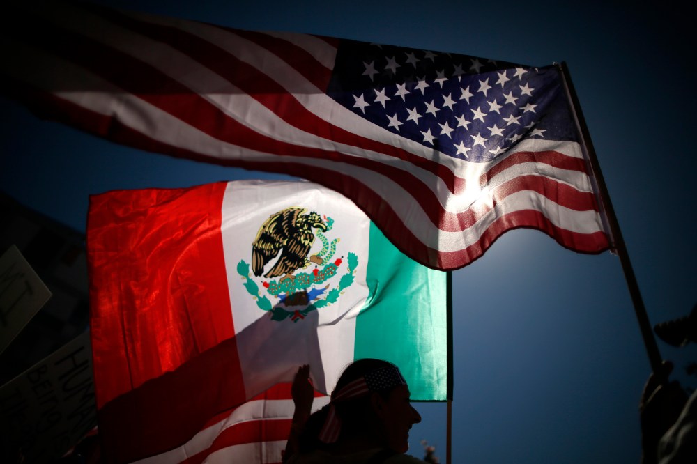 Protesters carry American and Mexican flags on their march to demand immigration reform in Hollywood