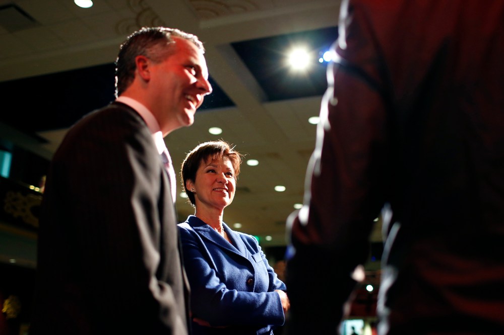 Republican David Jolly and Democrat Alex Sink, candidates for Florida's congressional District 13, chat on stage during a break as they participate in a candidate forum in Clearwater, Florida, February 25, 2014.