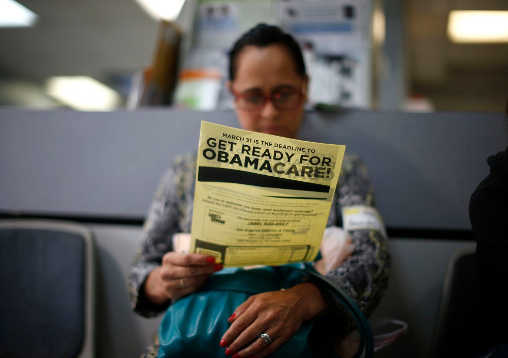 Arminda Murillo, 54, reads a leaflet at a health insurance enrollment event in Cudahy, Calif., March 27, 2014.