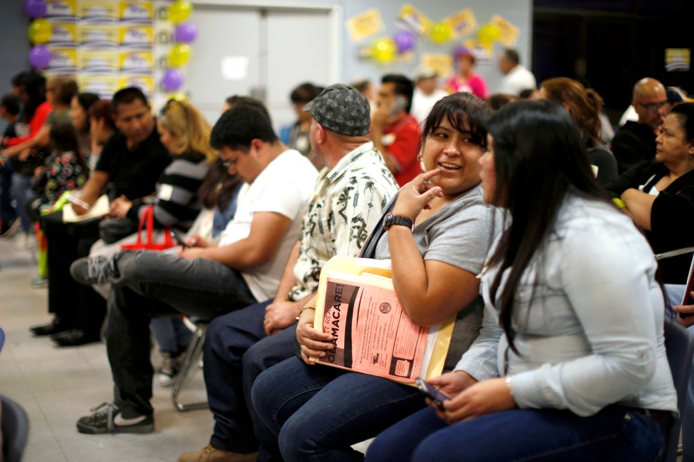People wait in line at a health insurance enrollment event in Cudahy, Calif. on March 27, 2014.
