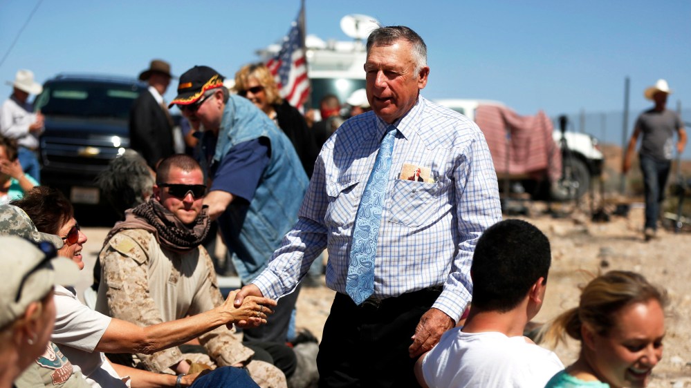 Rancher Cliven Bundy greets supporters before a roadside church service at a protest site in Bunkerville April 13, 2014.